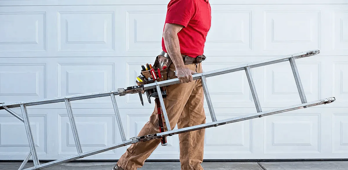 Garage door repair technician arriving with tools and ladder in El Paso, TX