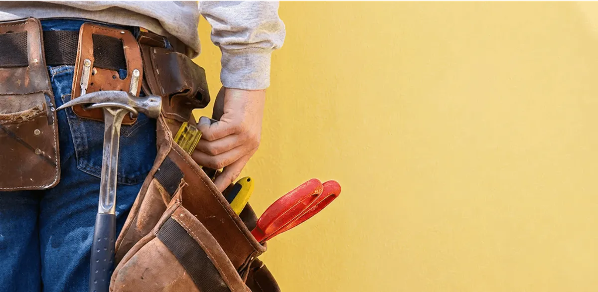 Handyman with tool belt ready for home repairs and maintenance in El Paso, TX