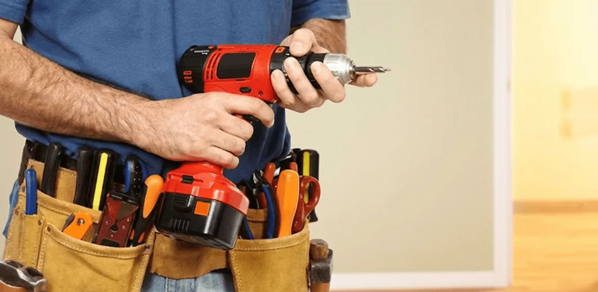 Handyman holding a power drill for home repairs and installations in El Paso, TX